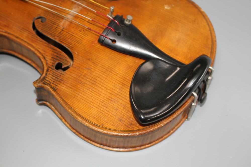 A violin with two piece back and bow, and a childs violin with bow, both with cases